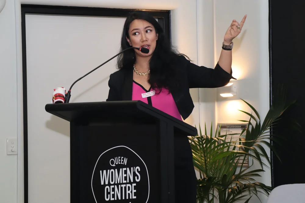 Thao Tran speaking at a Queen Women's Centre event